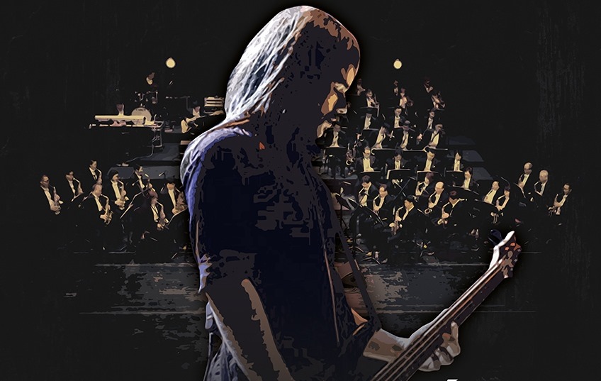Zdjęcie - plakat zapraszający na koncert Metallika Symfonicznie. Na plakacie postać gitarzysty na tle orkiestry symfonicznej.     