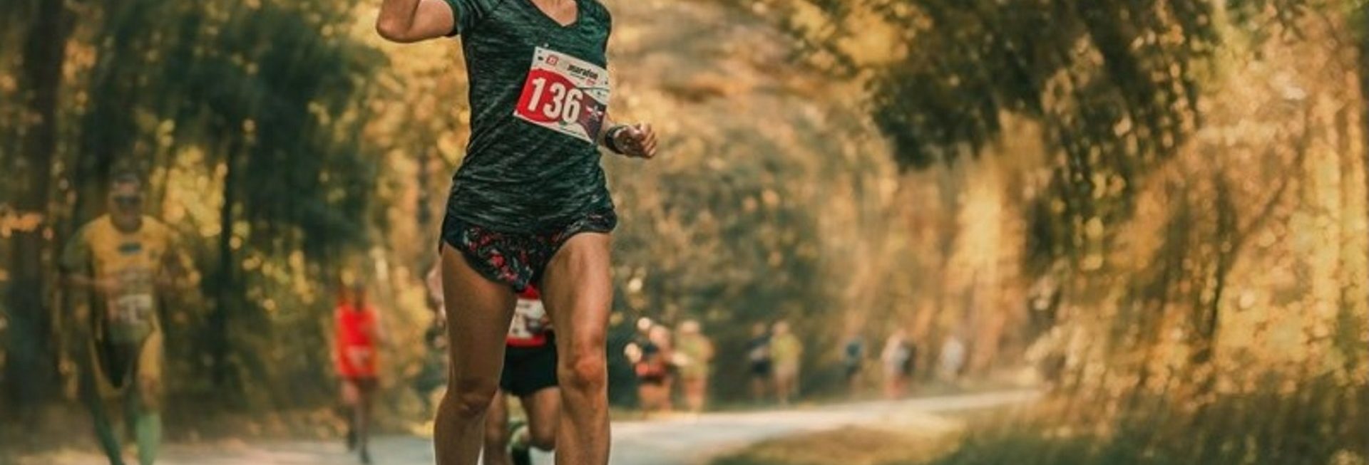 Zdjęcie przedstawiające biegaczkę podczas biegu w zawodach Półmaratonu Ełckiego.  