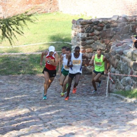 Zdjęcie zapraszające na kolejną edycję Biegu "Wokół Pasłęckich Murów Obronnych" Pasłęk.